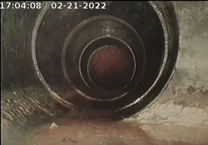 image of inside of a sewer pipe from a camera scope video